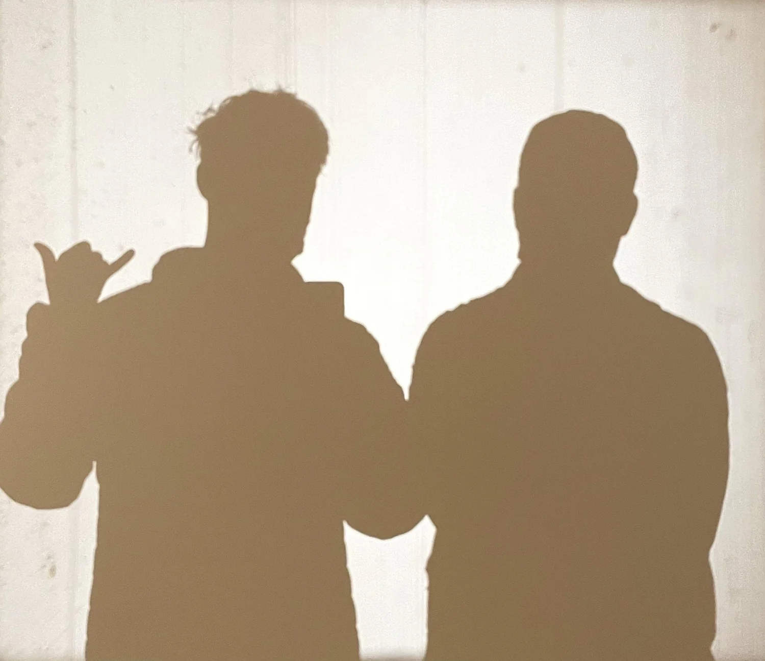 The two brothers behind BeatsBackground, photographed as silhouettes against a sunlit wall